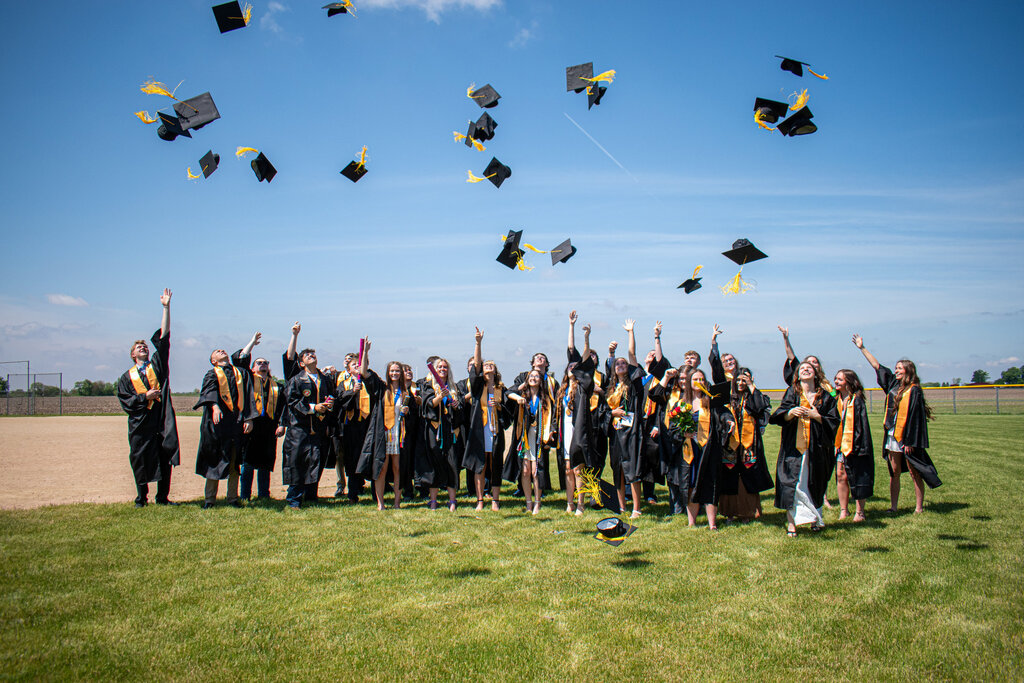 class of 2026 outside throwing their caps in the air!