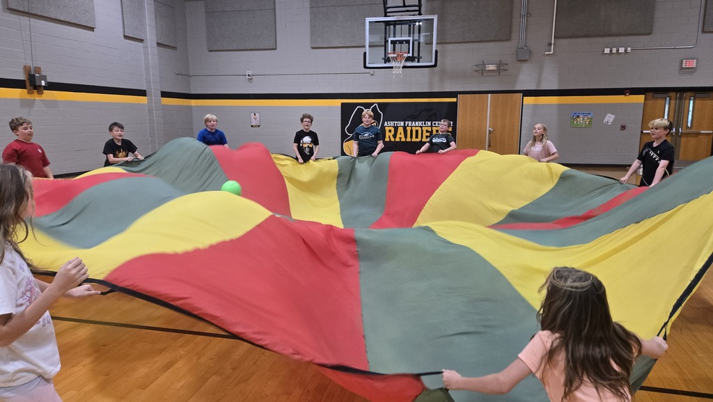 students playing parachute in the gym