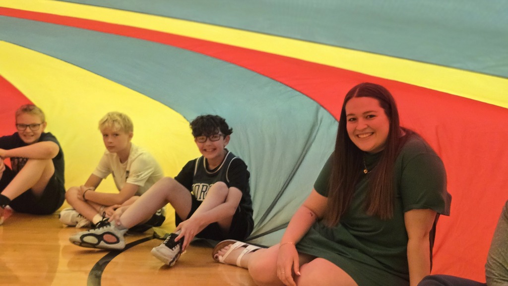 students playing parachute in the gym