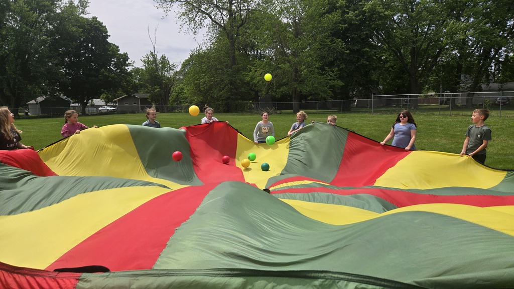 students playing parachute outside