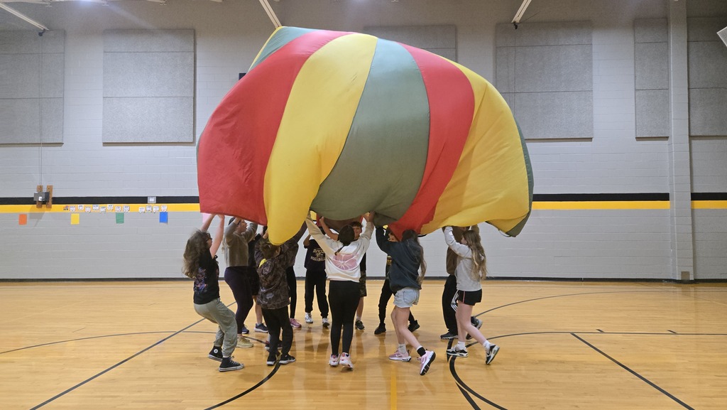 students playing parachute in the gym