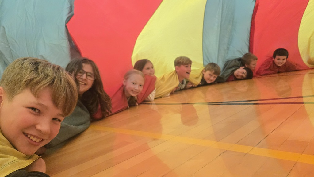 students playing parachute in the gym