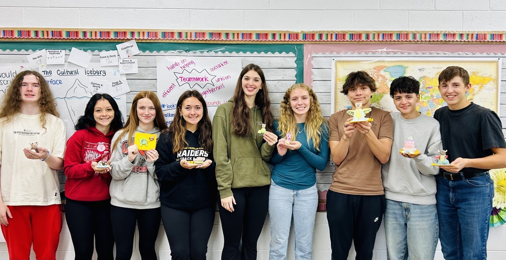 large group of students holding  Alebrijes
