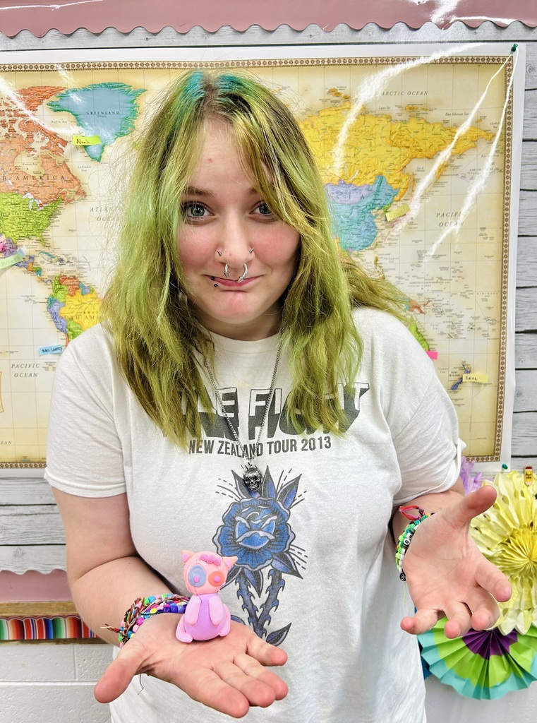 female student holding  Alebrijes