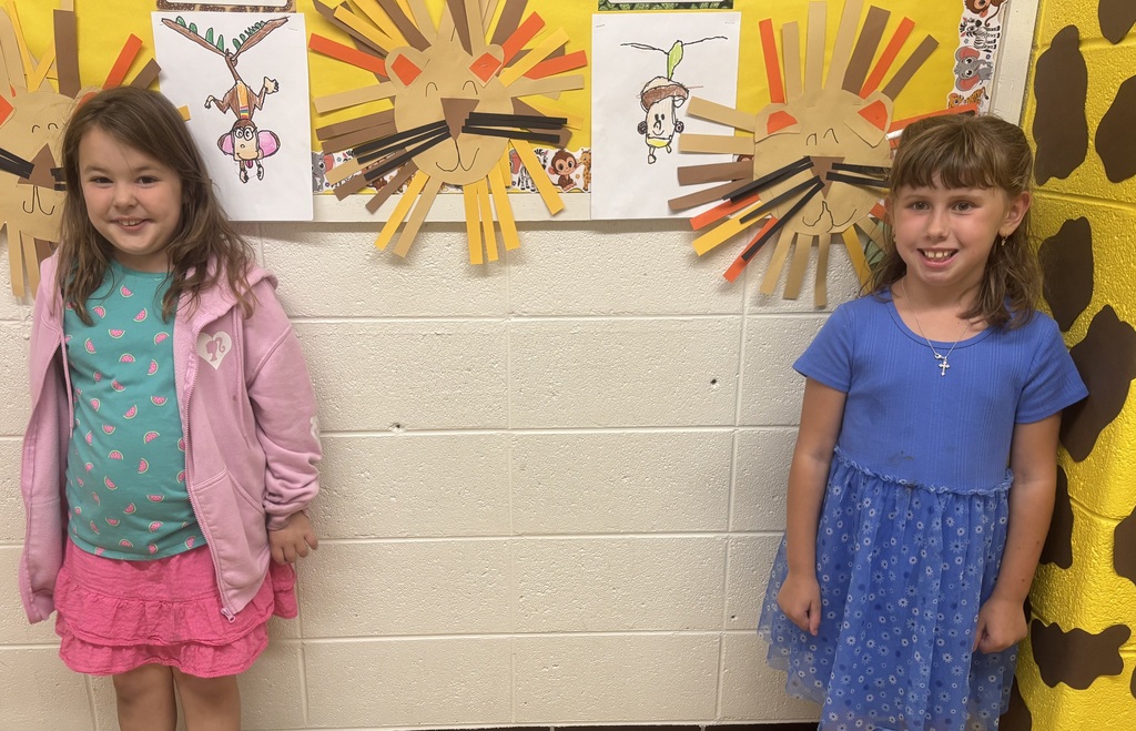 two female students in front of animal art