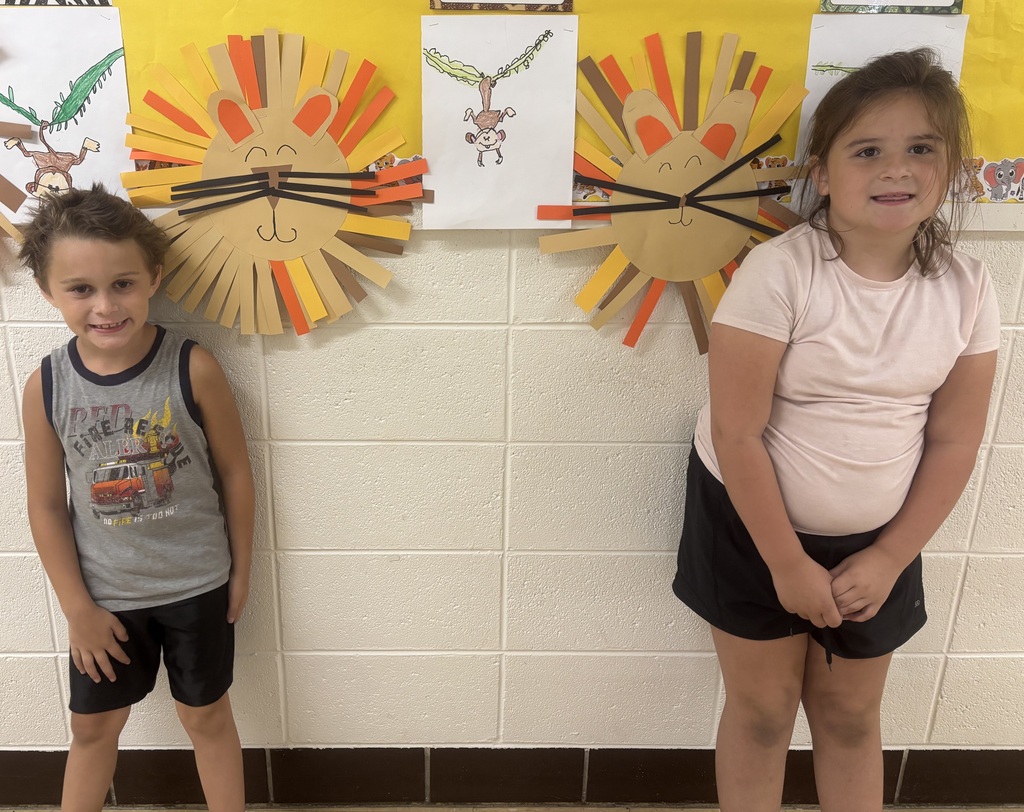 two students in front of animal art