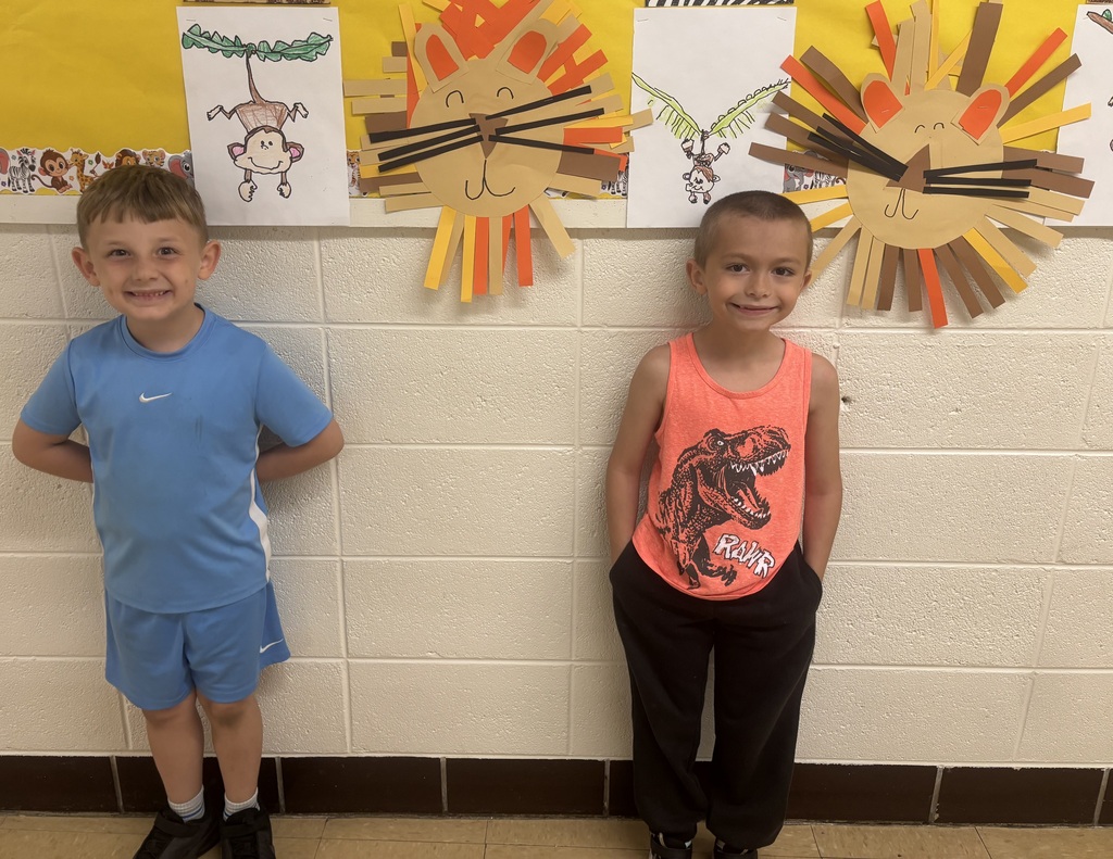 two male students in front of animal art
