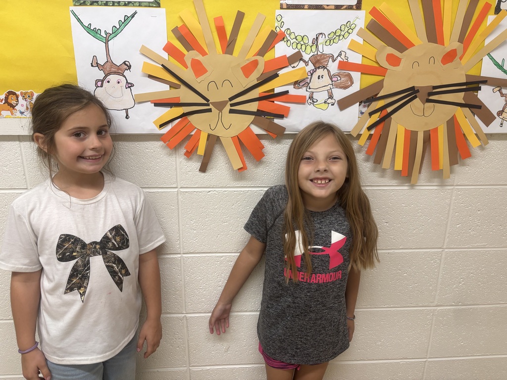 two female students in front of animal art
