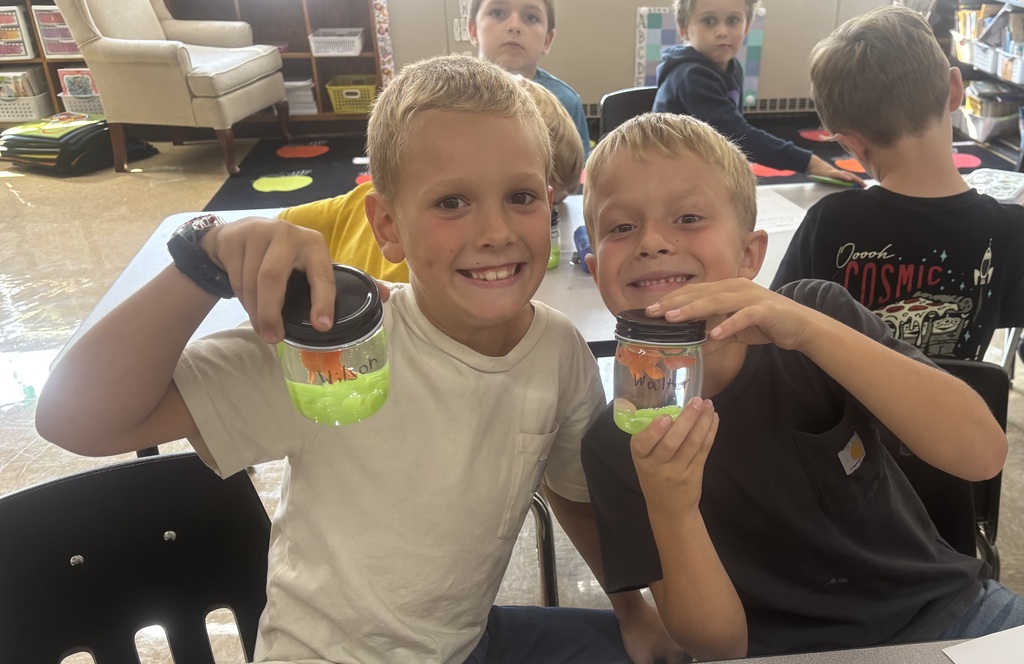 two male students posing with their magical fish