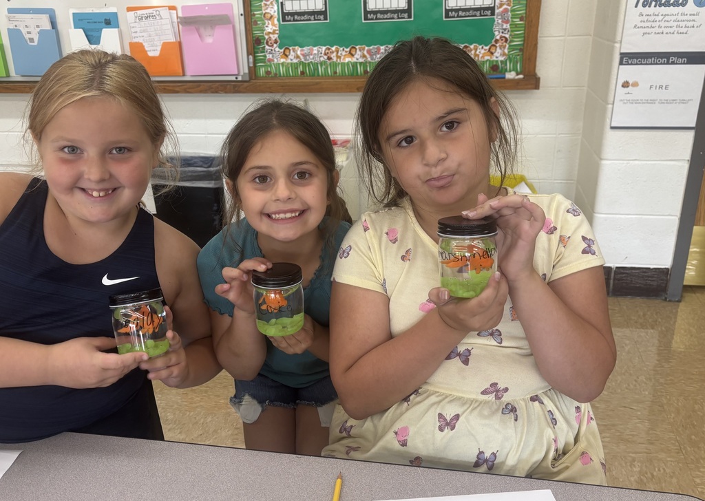 three female students posing with their magical fish