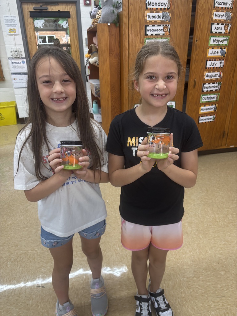 two female students posing with their magical fish