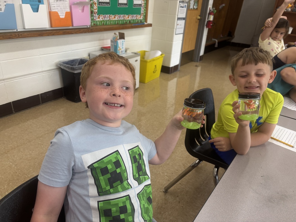 two male students posing with their magical fish