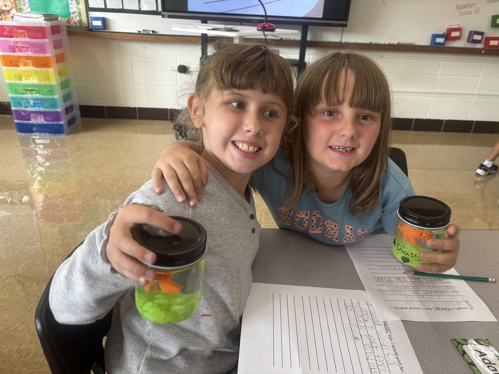 two female students posing with their magical fish
