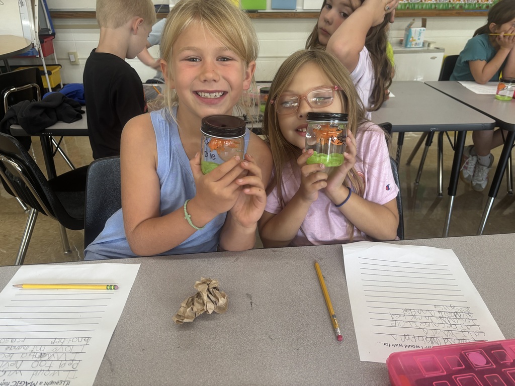 two female students posing with their magical fish