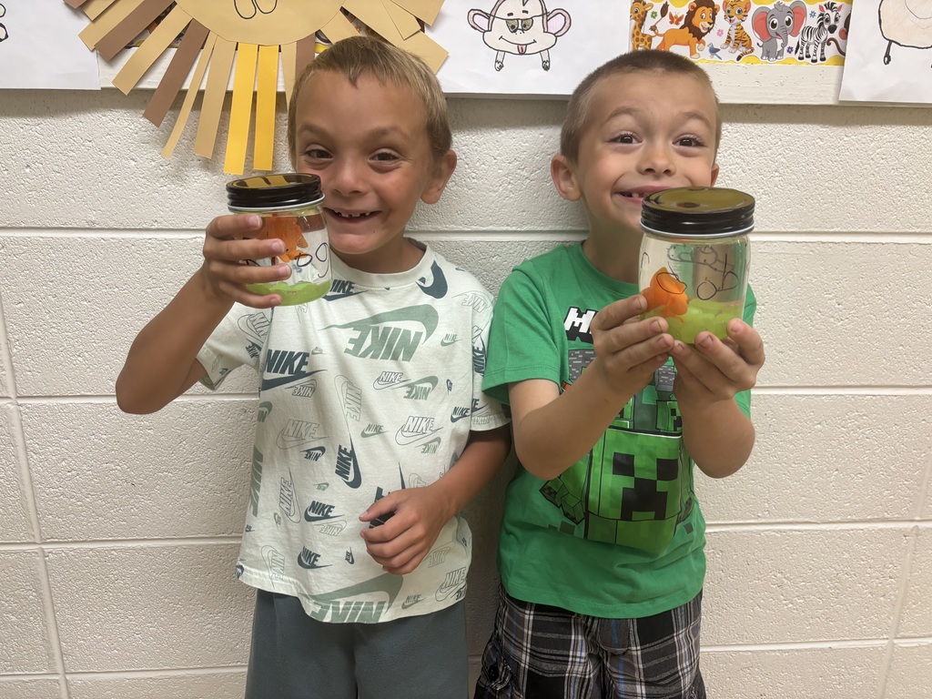 two male students posing with their magical fish