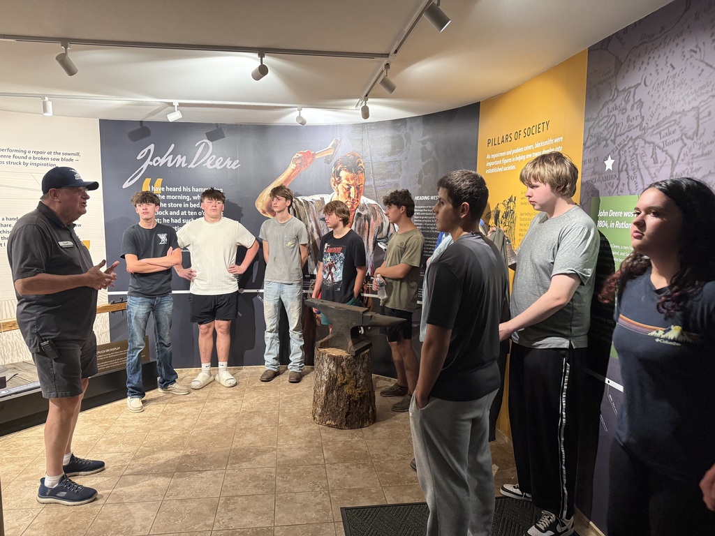 group of students at john deer museum listening tour
