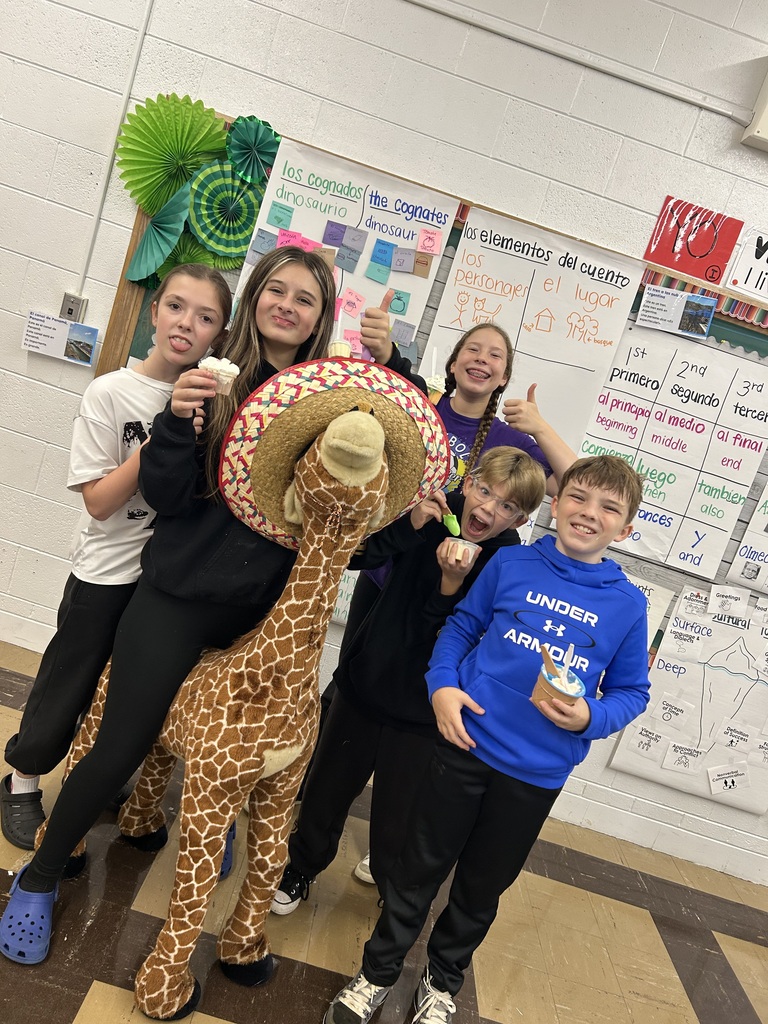 Five 7th grade girls eating ice cream with giant giraffe 