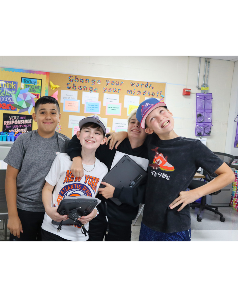 Four middle school boys act silly for the camera on the first day of school