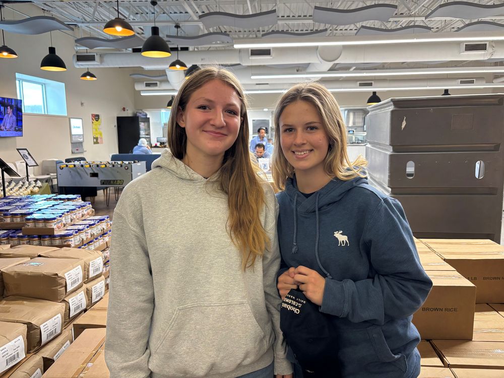 FFA students smiling with boxes in the background