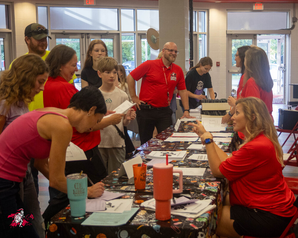 Afton Central School District students, families, teachers and staff gather in a room inside a school to have conversations about the upcoming school year