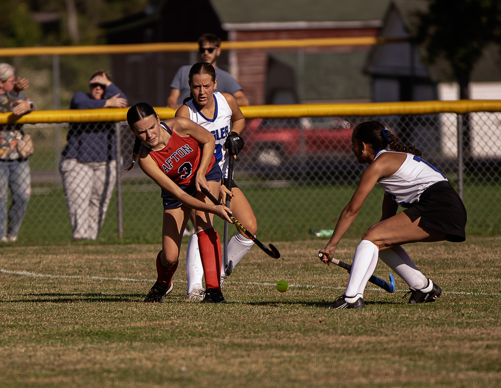Afton player in action with field hockey stick