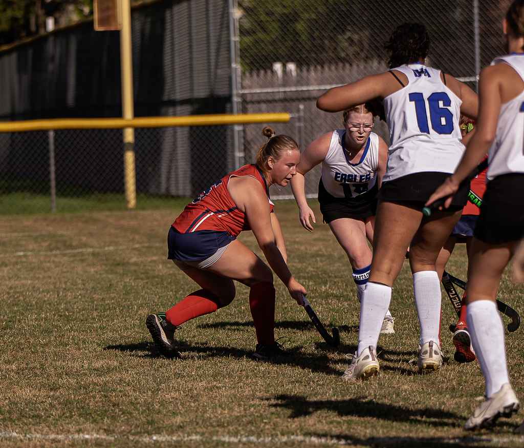 Afton player in action with field hockey stick