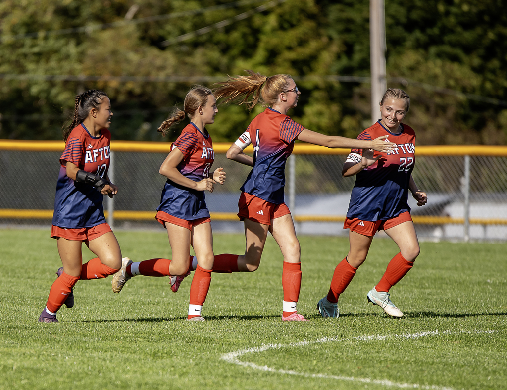 Afton players celebrating a goal