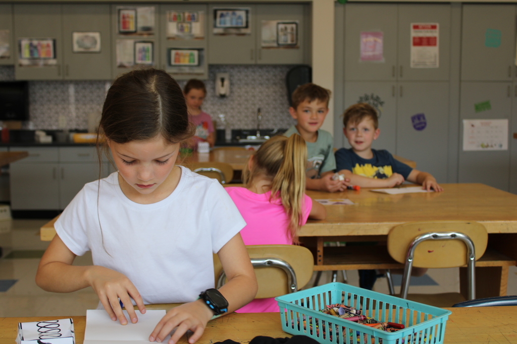 Afton Elementary student folding a cube