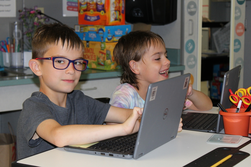 Afton students with computers smiling