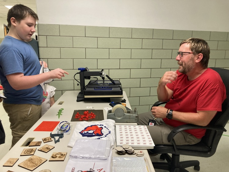 afton student looking at 3D printer
