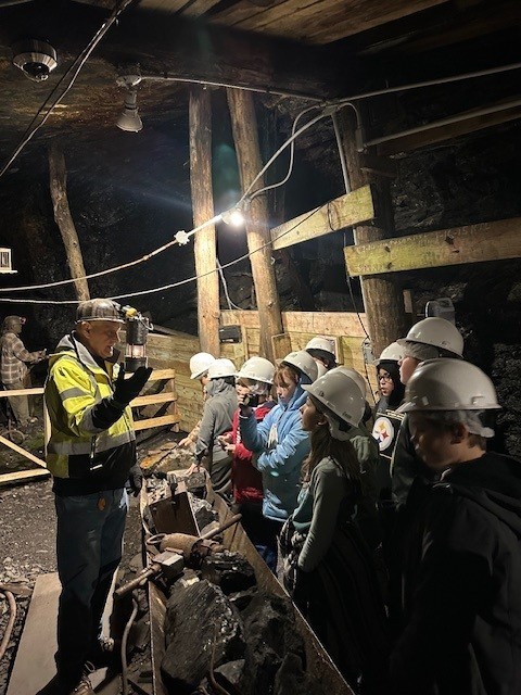 Students learning from coal miner