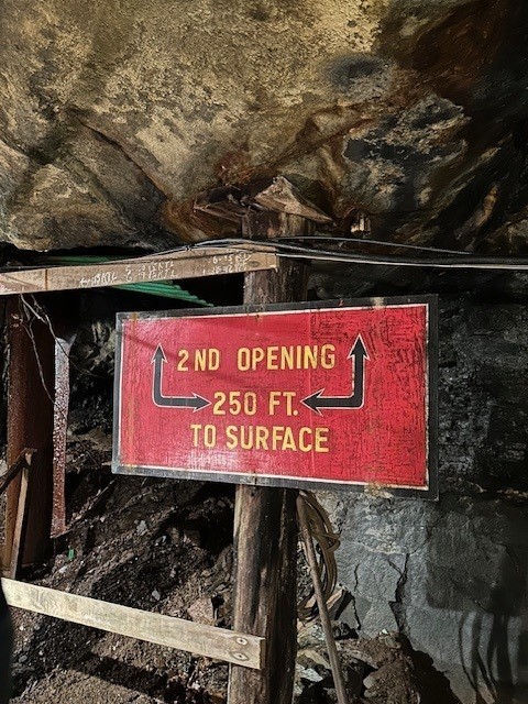 Sign in cave saying 2nd opening 250 feet to surface