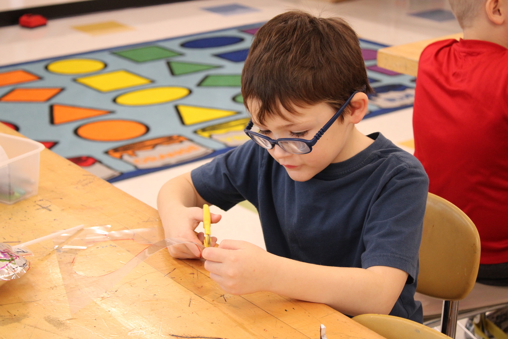 Student cutting with scissors
