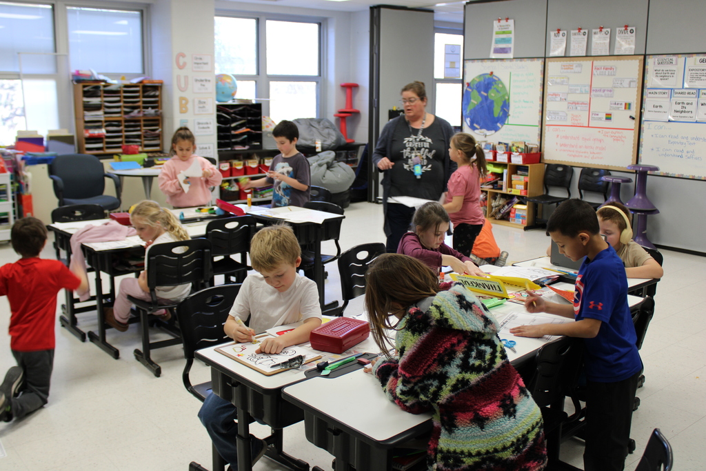 Teacher giving instructions to students working in the classroom