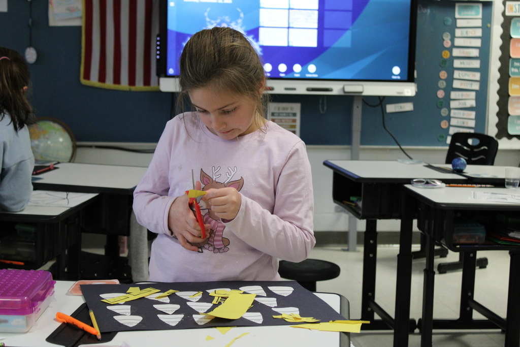 Student working on cutting candy corn
