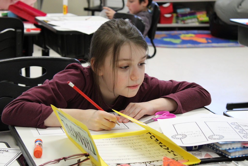 Afton student working with paper and pencil