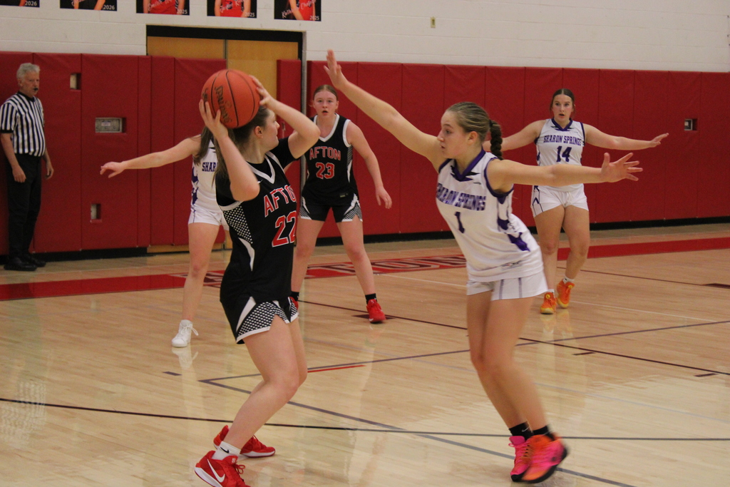 Afton girls basketball player in posession of the ball