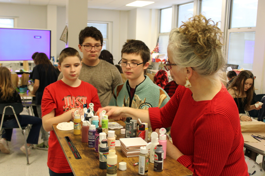 Ms. Wheeler handing paints to students