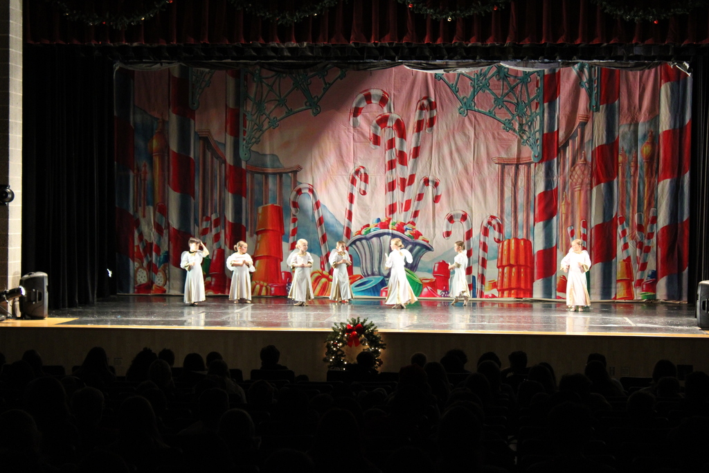 little children dancing on stage in costumes