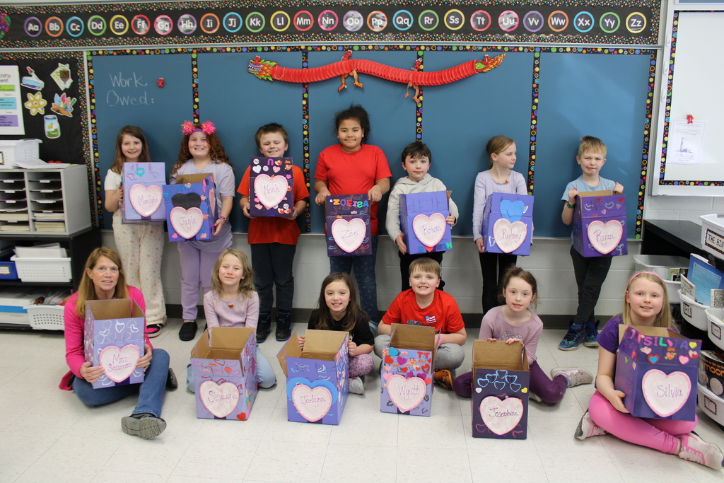 Class photo of students with Valentines day boxes