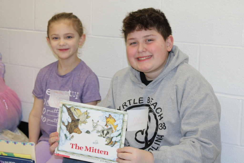 students smiling with books