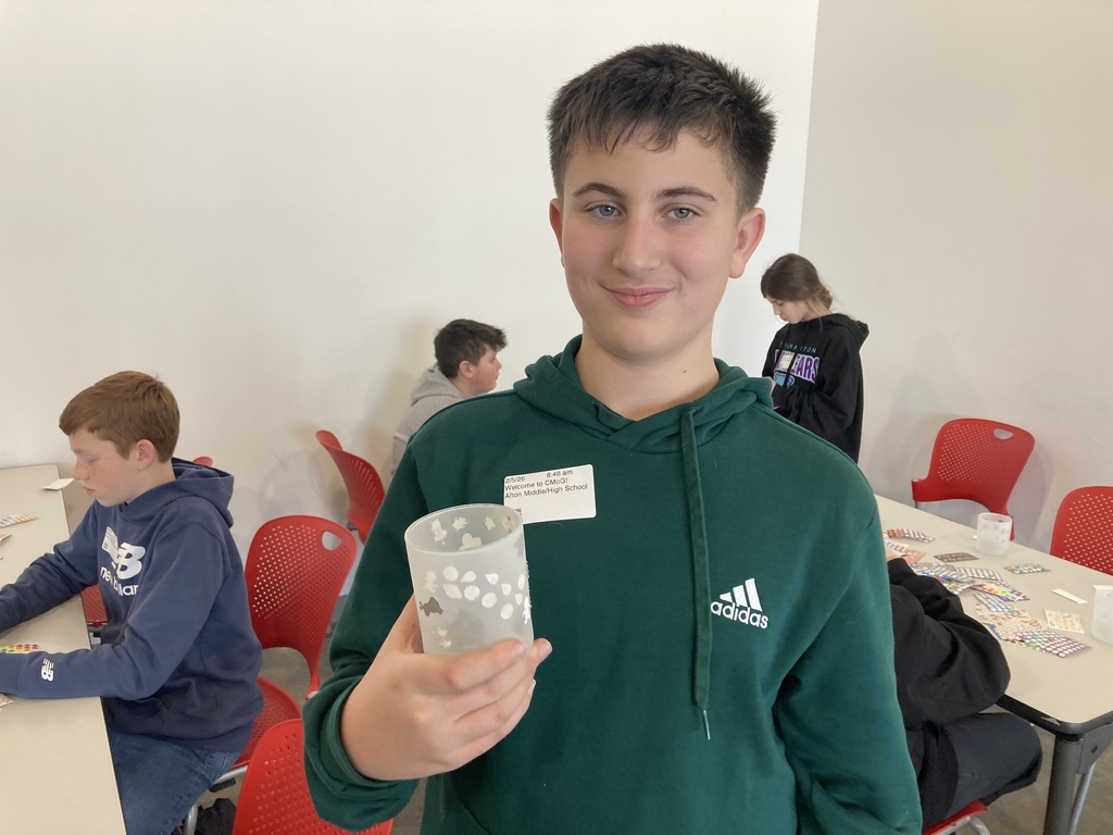 Student with sandblasted cup