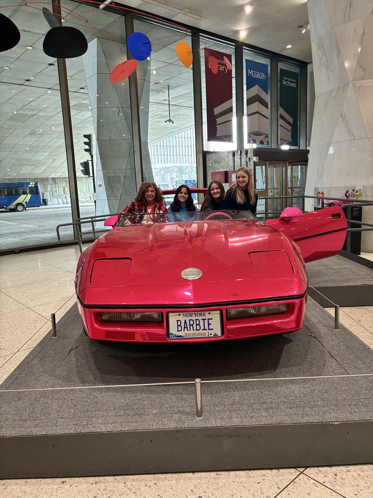 Students with teacher in a car