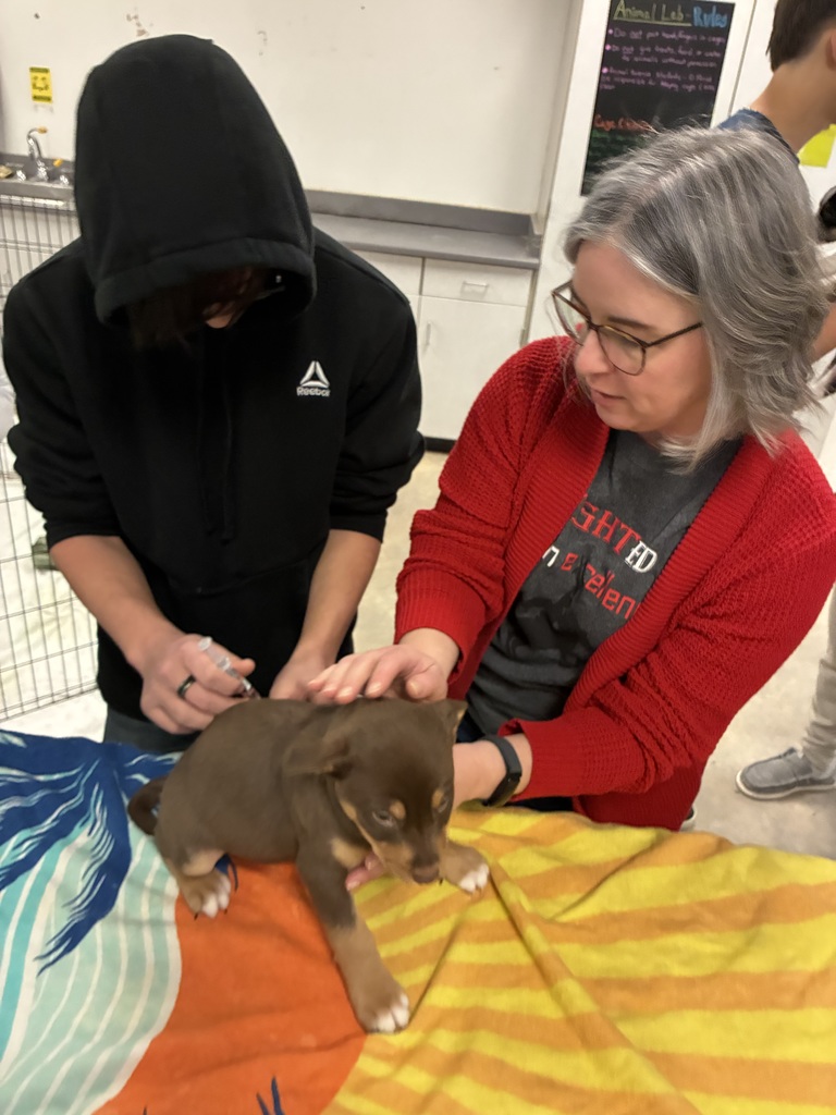 Student and teacher with puppy