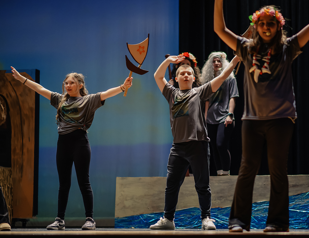 Students dancing on stage in costume