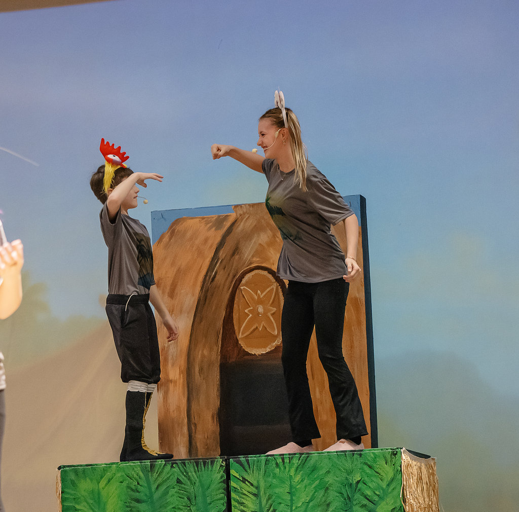 Students in costume on stage