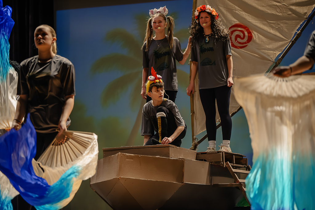 Students on boat on stage