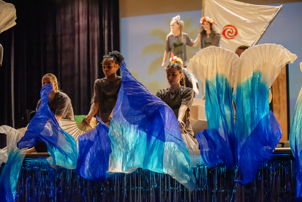 Students on stage with banners