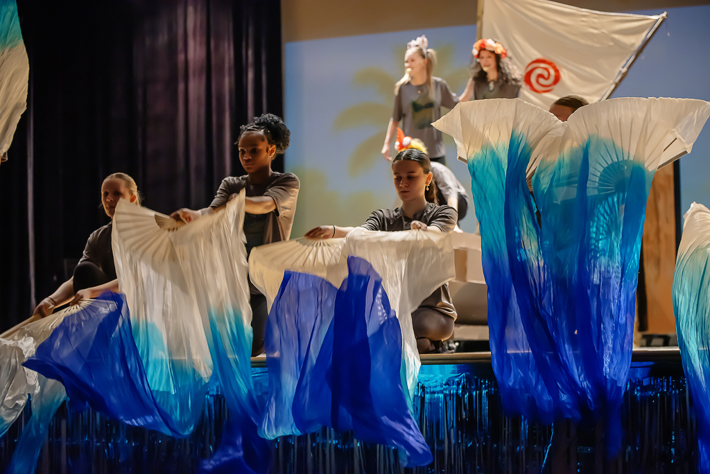 Students on stage with banners