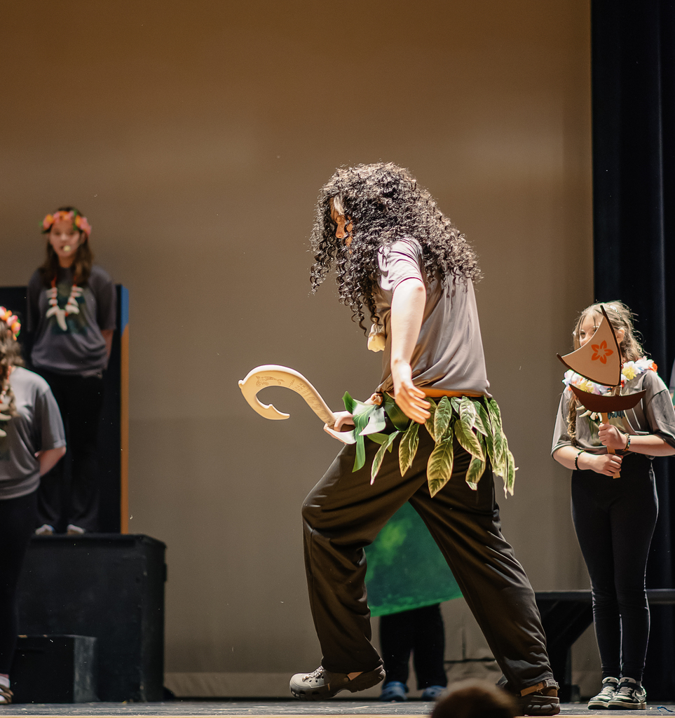 Afton drama student on stage in costume